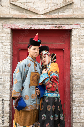 Young Mongolian couple in a traditional 13th century costume in a temple. Ulaanbaatar, Mongolia.