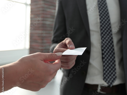 Close-up of two businesspeople exchanging visiting card