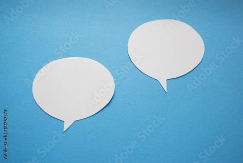 Speech bubbles on blue paper background.