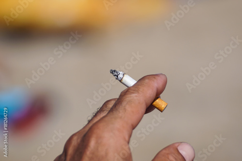 Smoking with cigarette butts ashtray on the sand on the beach and travel activity