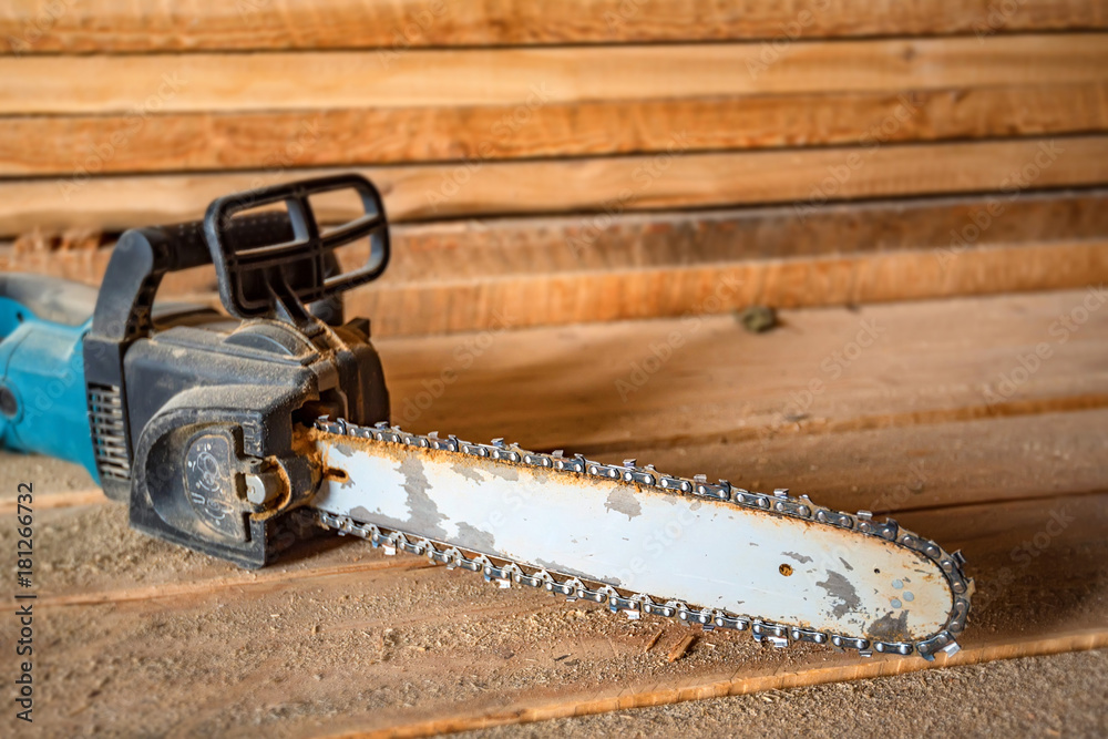 Chainsaw on lumber background