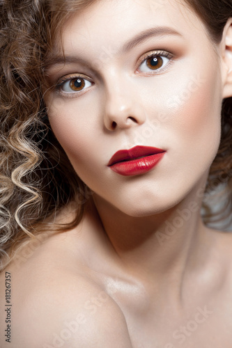 Young beautiful girl with clean perfect skin with red lipstick