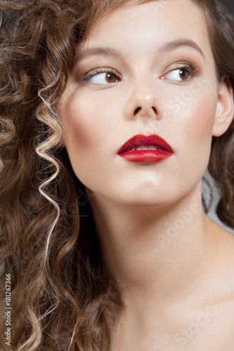 Young beautiful girl with clean perfect skin with red lipstick