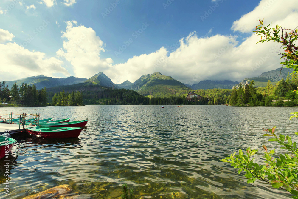 Panorama mountain lake Strbske Pleso in the Tatra mountains. Summers colors and boat for swimming Panorama mountain lake Strbske Pleso in the Tatra mountains. Summers colors and boat for swimming