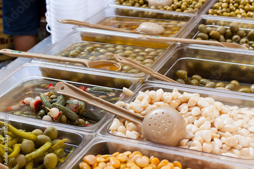 Assortment of pickled olives and lima beans for sale at Sineu market, Majorca, Spain photo