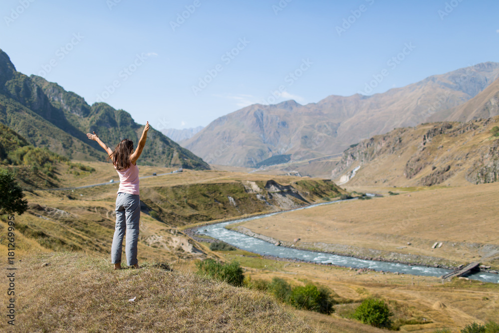 woman admires the view of the mountains