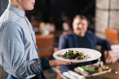 Photography Waiter serving salad at restaurant