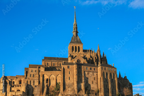 Le Mont Saint-Michel is a rocky tidal island in Normandy with blue sky, it is one of the most visited tourist sites in France.