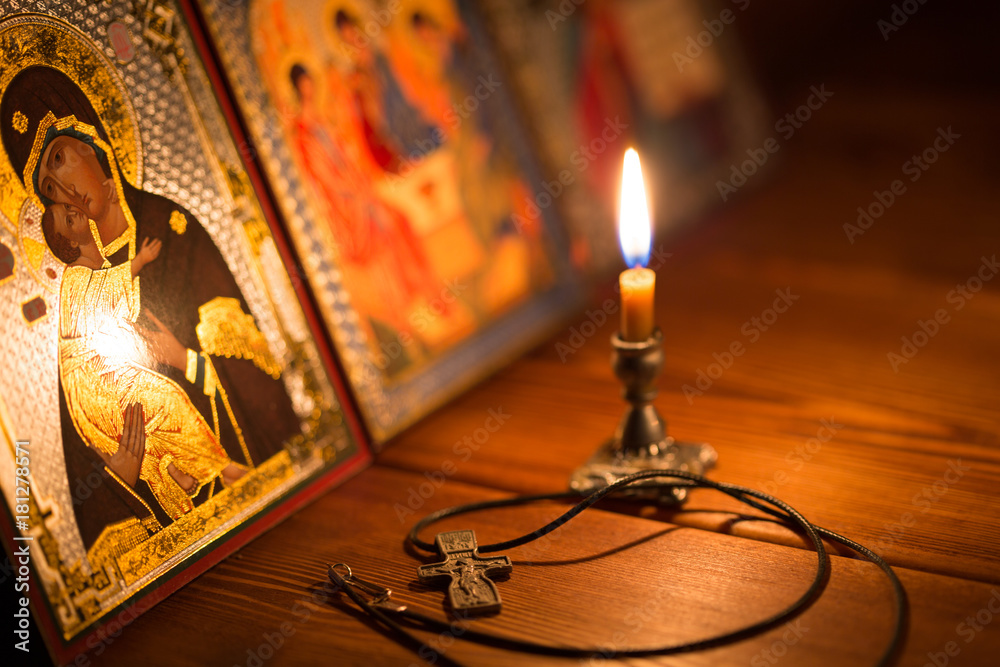 Fototapeta premium burning candle in a dark room, orthodox