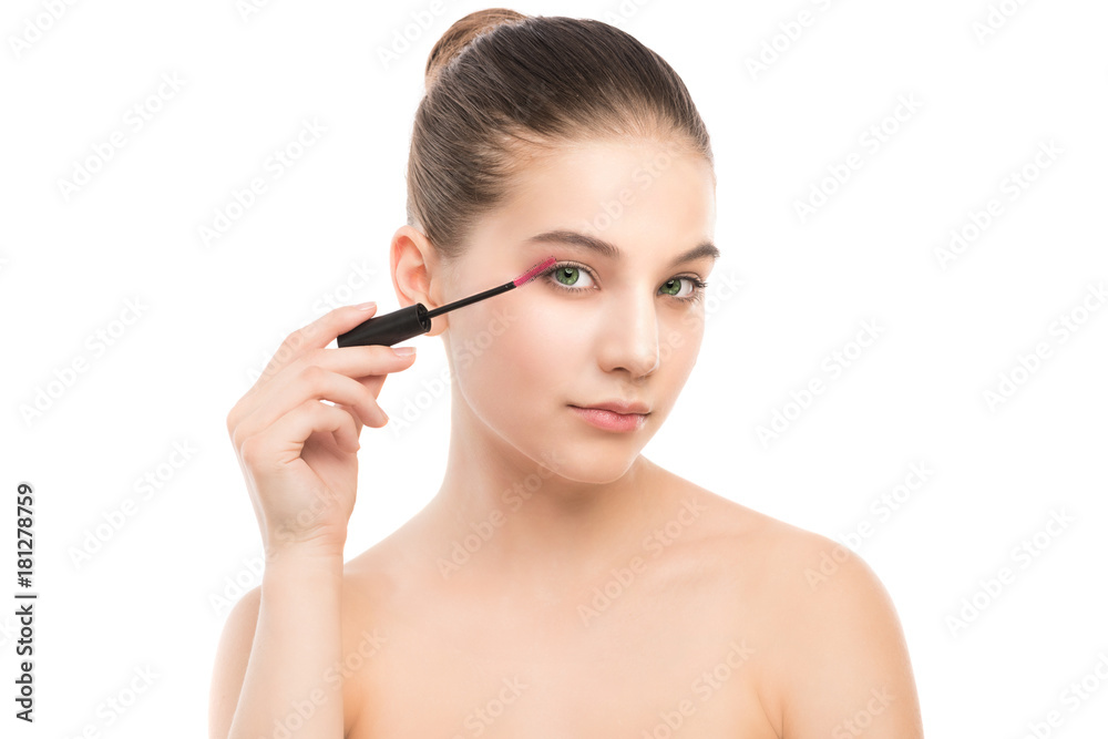 Eye make up apply. Mascara applying closeup, long lashes. Mascara brush. Portrait of beautiful young brunette woman with perfect fresh clean face skin. Eyelashes extensions. Make-up for green eyes