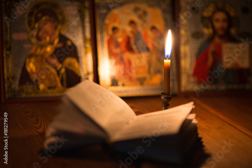 Fotografiet burning candle in a dark room, orthodox