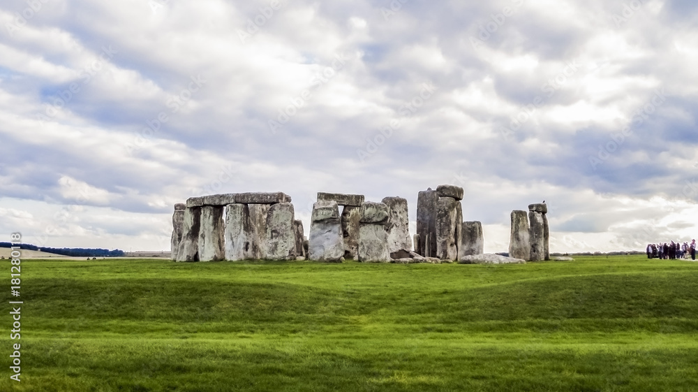 Stonehenge prehistoric monument,  green grass, clouds, panoramic view - Wiltshire, Salisbury, England, UK