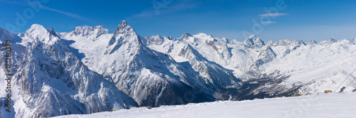 Snow covered the ski slopes against the backdrop of the mountain peaks. © explorich