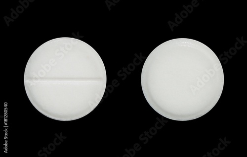 medical tablet close-up on an isolated black background