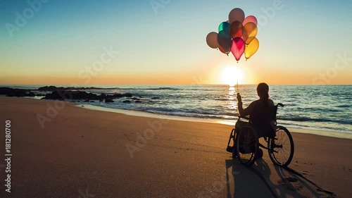 Happy woman on the beach holding ballons