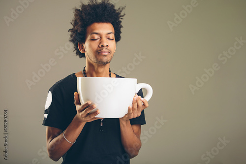 Canvas Print man holding funny huge and oversized cup of black coffee