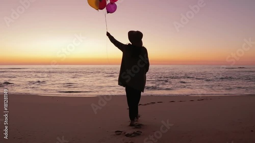 Woman walking with balloons