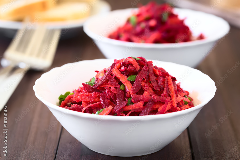 Raw grated beetroot, apple and carrot salad with parsley, photographed with natural light (Selective Focus, Focus in the middle of the image) Raw grated beetroot, apple and carrot salad with parsley, photographed with natural light (Selective Focus, Focus in the middle of the image)
