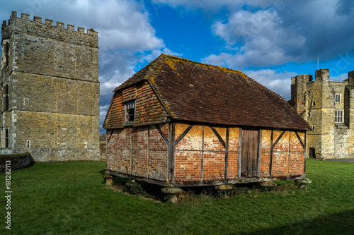Little, ancient house in between two ancient towers in England.