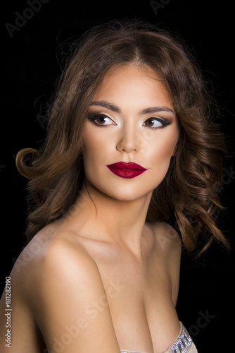 beautiful girl with red lips and nails  glamour evening makeup and hair concept