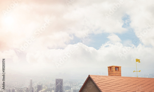 Brick house roof and modern cityscape at background