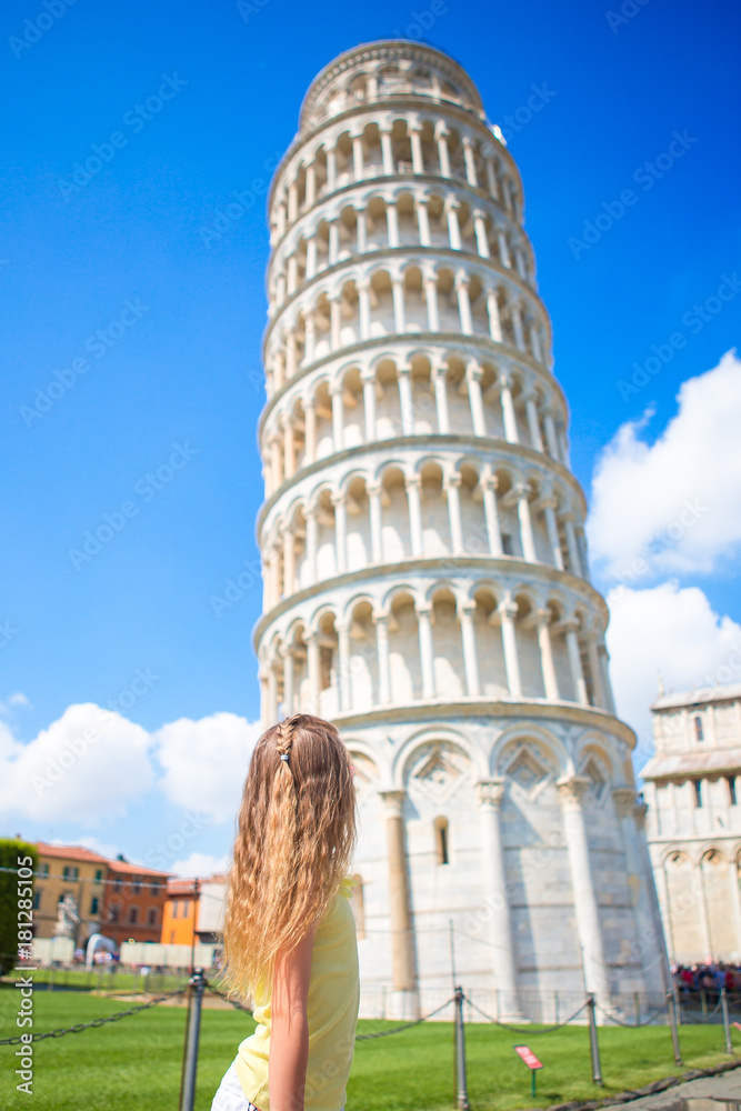 Little girl on italian vacation near the famous Leaning Tower of Pisa, Italy