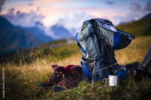 The backpack stands on the background of high mountains. Around the wonderful landscape. Evening. Sunset. Tourism in the Caucasian Mountains in Georgia.