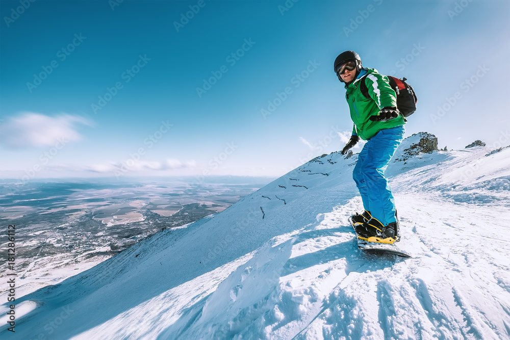 Snowboarder stay on the mountain top, Tatranska Lomnica, Slovakia