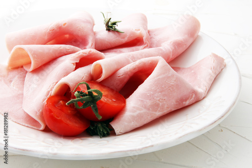 Sliced ham on white background. Fresh prosciutto. Pork ham sliced.