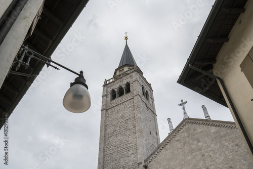 Detail of the bell tower and the church of Sant'Andrea apostle in Venzone, Friuli, Italy 