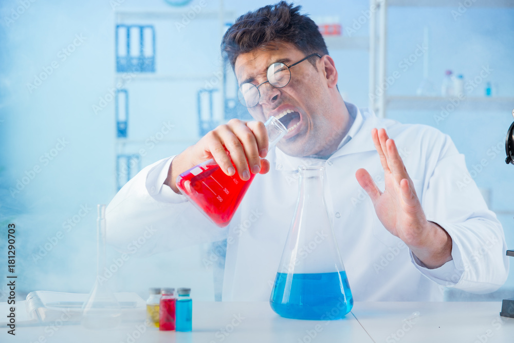 Funny mad chemist working in a laboratory Funny mad chemist working in a laboratory
