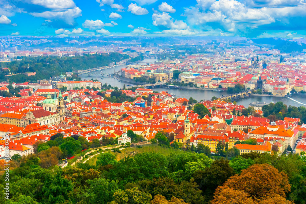 Beautiful panorama of Prague from the top of the Petrin gardens in Prague, Czech Republic. Red tiled roofs of Prague and bridges on the Vltava