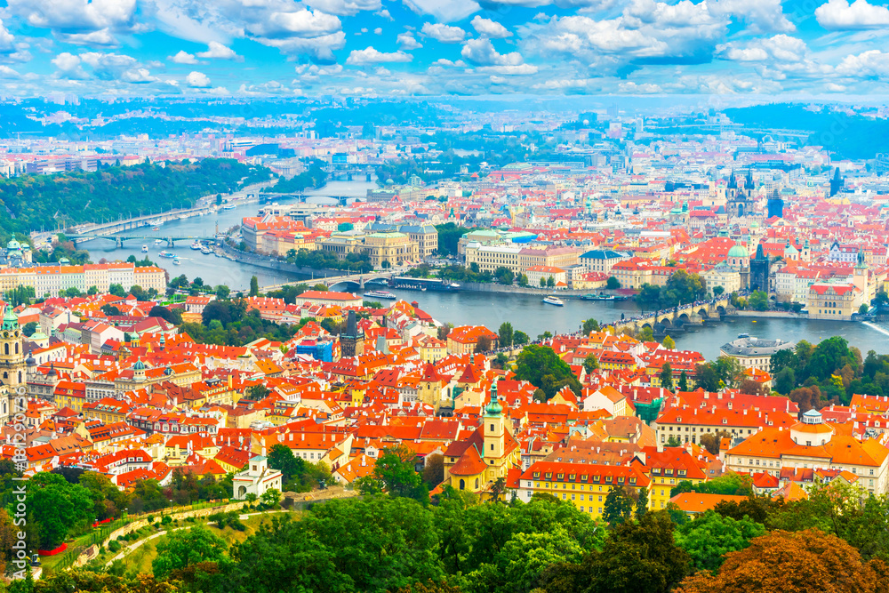 Beautiful panorama of Prague from the top of the Petrin gardens in Prague, Czech Republic. Red tiled roofs of Prague, Charles Bridge and other bridges on the Vltava