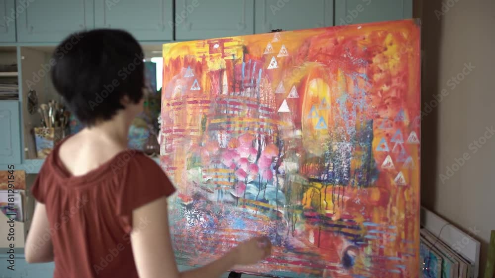 Woman artist painting an abstract painting in the art studio. 4 k Woman artist painting an abstract painting in the art studio. 4 k