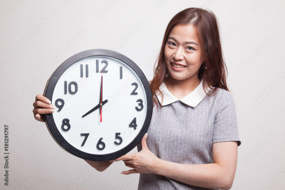 Young Asian woman with a clock. Young Asian woman with a clock.