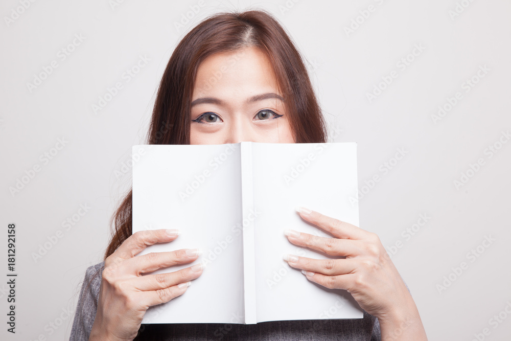Young Asian woman with a book. Young Asian woman with a book.