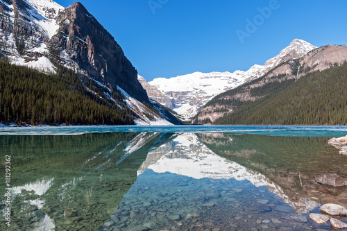 Snowy mountain reflection on lake Louise - Banff , Alberta, Canada