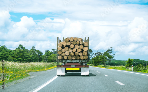 Logging truck driving on State Highway One in Northland, North Island, New Zealand, NZ