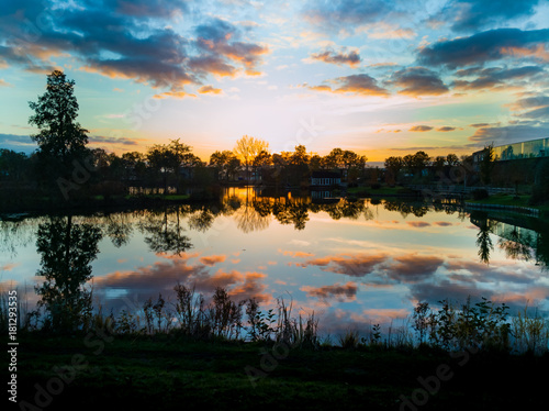 Small forest lake at colorful sunset