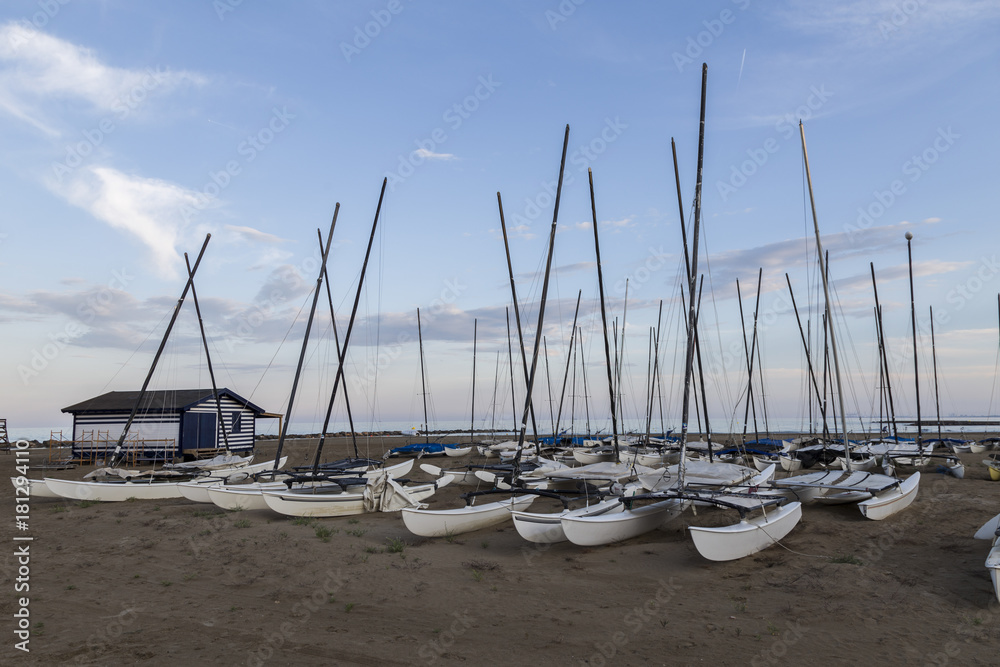 boats in the sand on the beach.