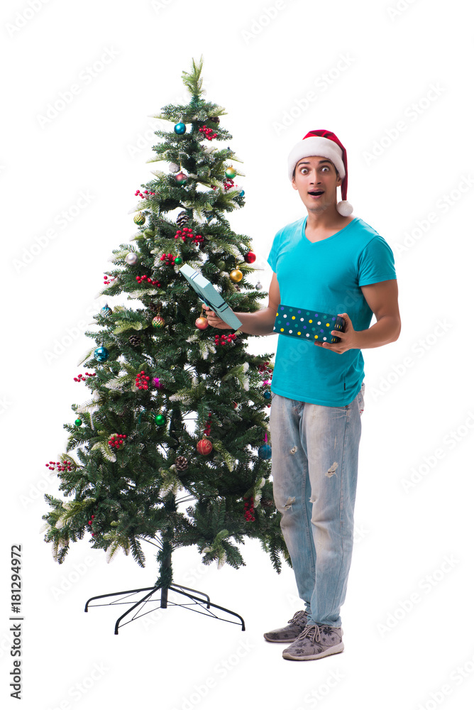 Young man decorating christmas tree isolated on white Young man decorating christmas tree isolated on white