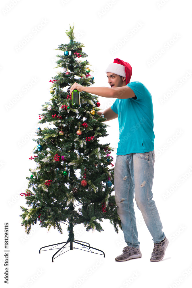 Young man decorating christmas tree isolated on white Young man decorating christmas tree isolated on white