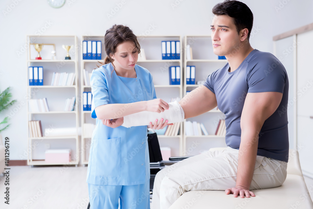 Doctor and patient during check-up for injury in hospital Doctor and patient during check-up for injury in hospital