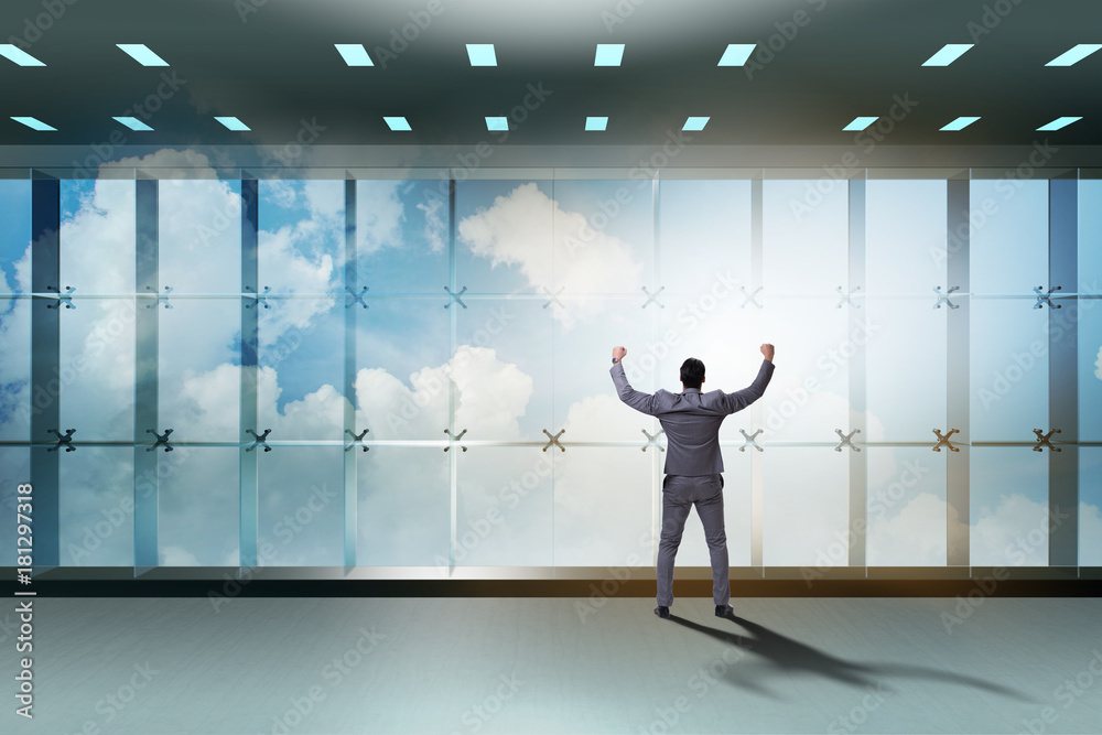 Fototapeta premium Businessman in front of office window thinking of new challenges