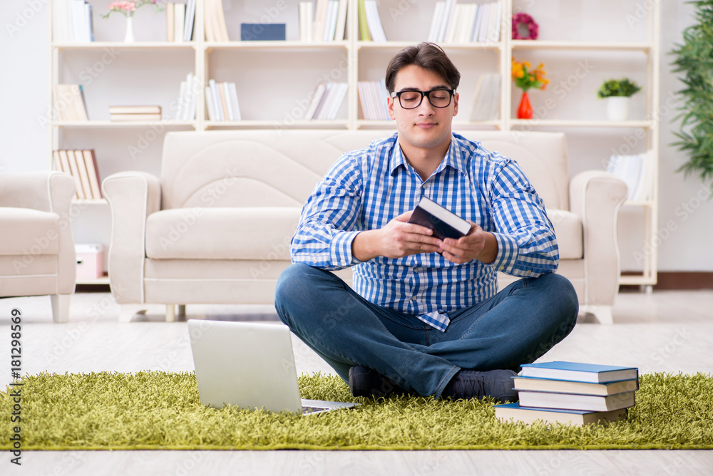 Young handsome man sitting on floor at home Young handsome man sitting on floor at home