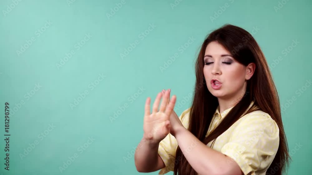 Young woman say no, trying to avoid offer, rejecting gesture, disagree sign. Serious sad face expression. Green background with copy space 4K ProRes HQ codec Young woman say no, trying to avoid offer, rejecting gesture, disagree sign. Serious sad face expression. Green background with copy space 4K ProRes HQ codec
