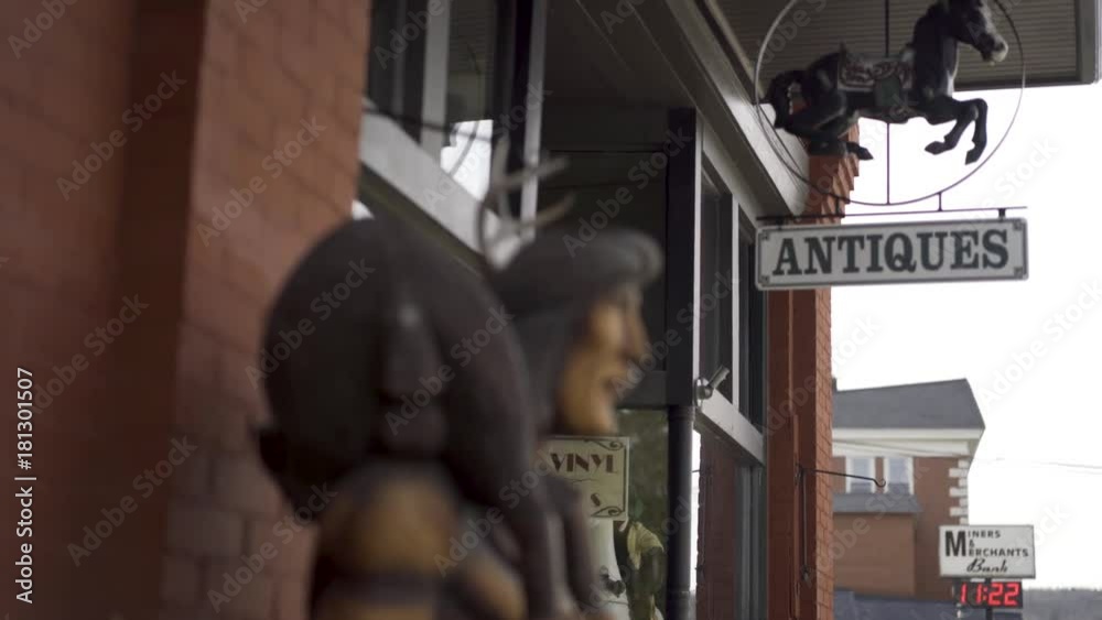 Steadicam shot of “Antiques” store sign with child’s rocking horse. Steadicam shot of “Antiques” store sign with child’s rocking horse.