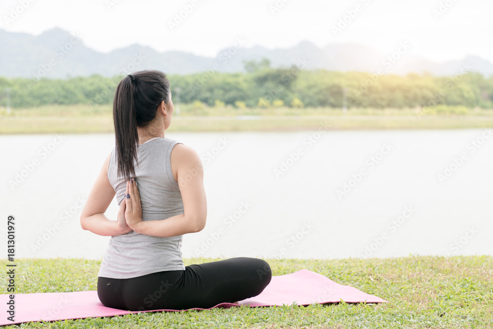 young woman exercising and sitting in yoga position
