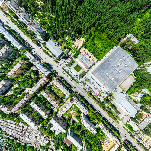 Aerial city view with crossroads and roads  houses  buildings  parks and parking lots  bridges. Helicopter drone shot. Wide Panoramic image.