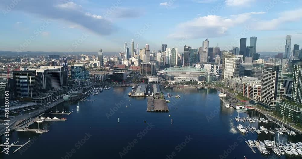 Aerial flying towards waterfront on Yarra river in Docklands suburb of Melbourne with view of city CBD towers.
Aerial flying towards waterfront on Yarra river in Docklands suburb of Melbourne with view of city CBD towers.